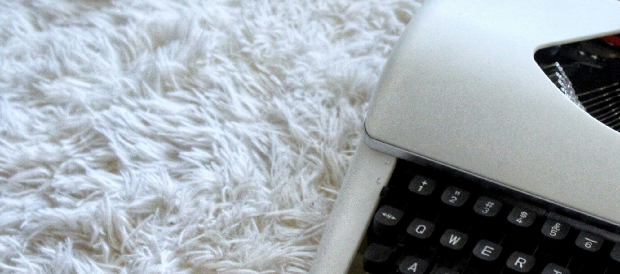 deep pile white carpet and white portable typewriter